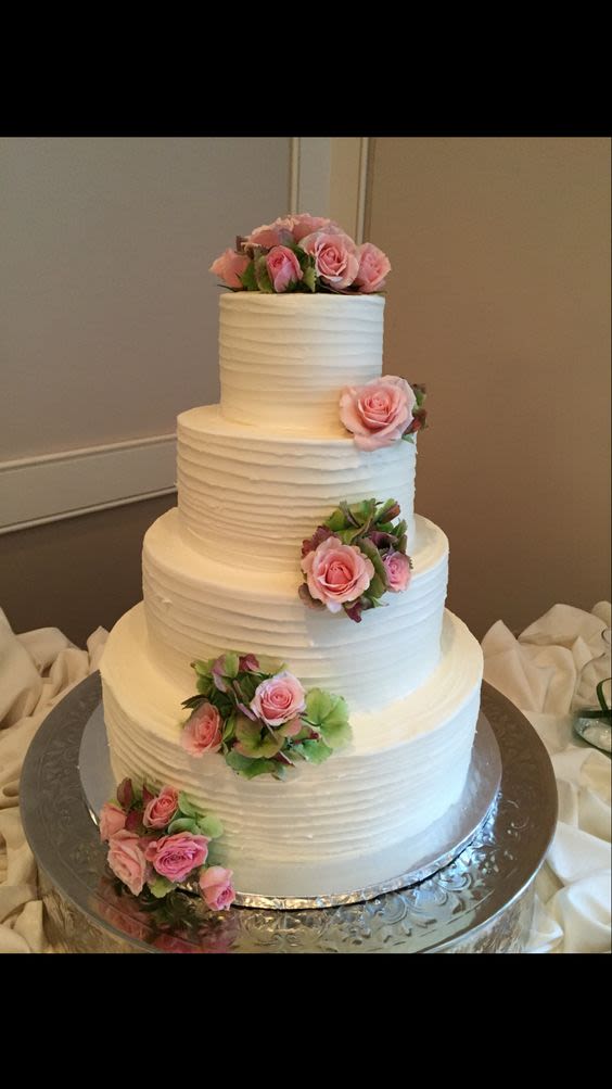 Uniquely Cakes white tiered wedding cake with pink flowers